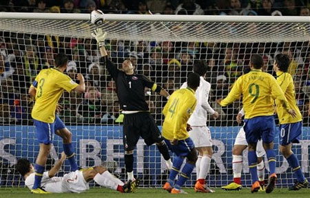 Chile goalkeeper Claudio Bravo, third from right in back, fails to stop a goal by Brazil's Juan, center foreground, during the World Cup round of 16 soccer match between Brazil and Chile at Ellis Park Stadium in Johannesburg, South Africa, Monday, June 28, 2010.